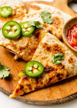 veggie quesadillas topped with sliced jalapeno and cilantro