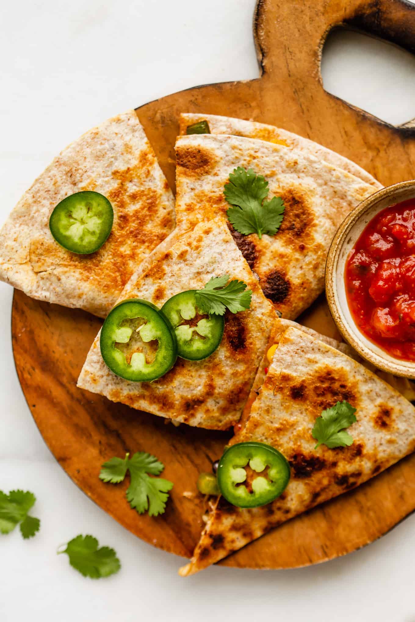 veggie quesadillas cut up on a wood board