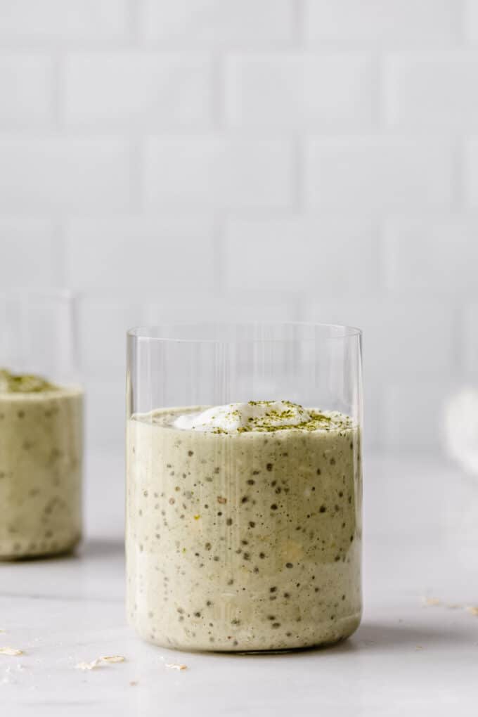 matcha overnight oats in a cup on a marble counter
