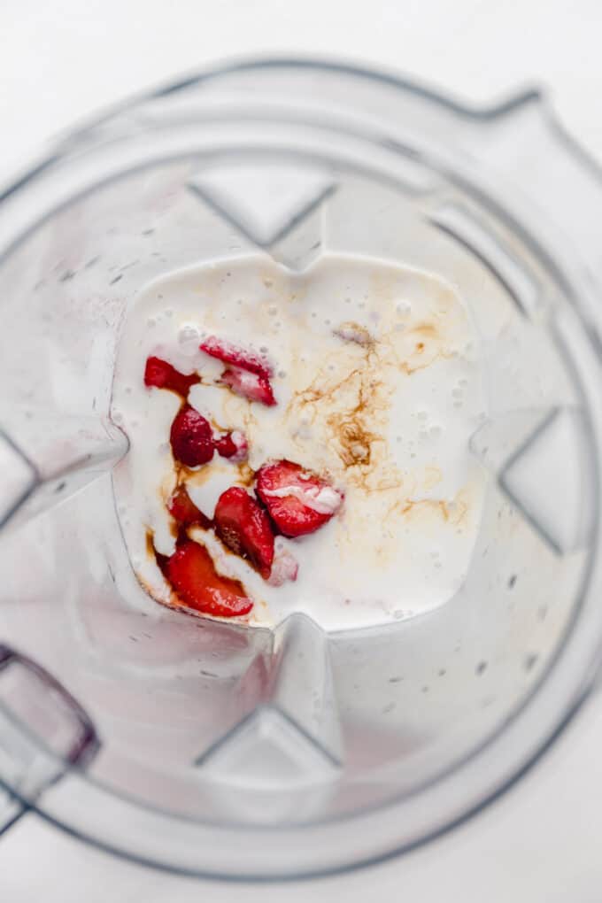 strawberries, vanilla extract and coconut milk in a blender