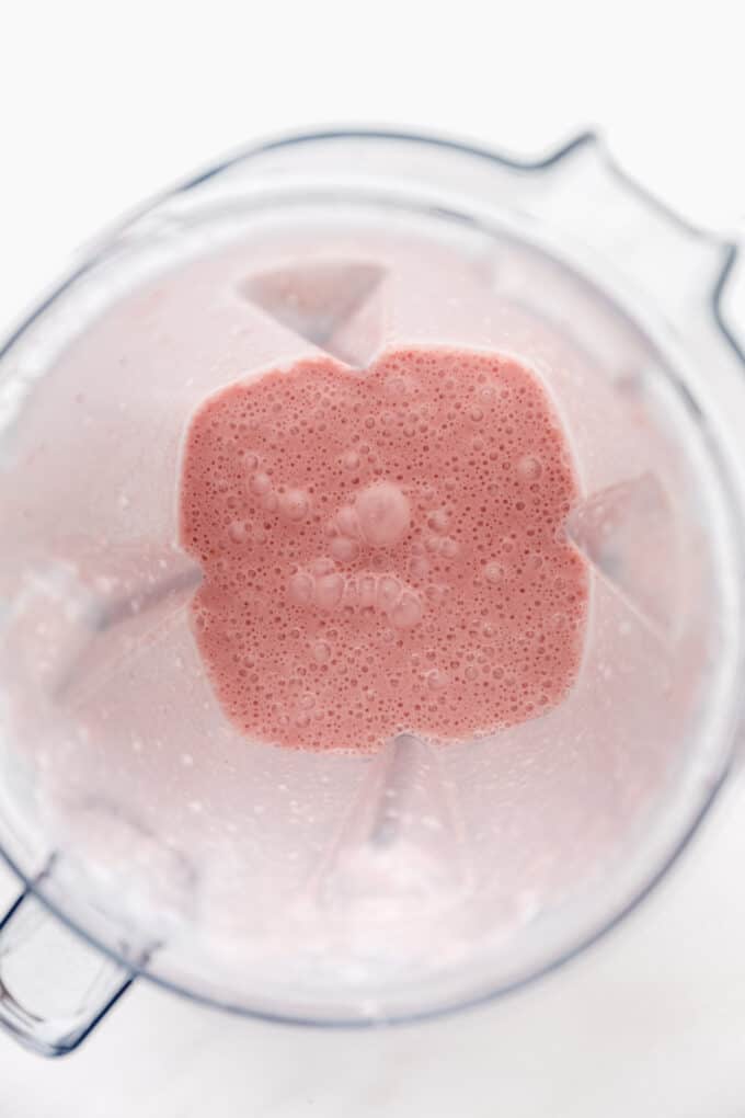 blended strawberry milk in a blender