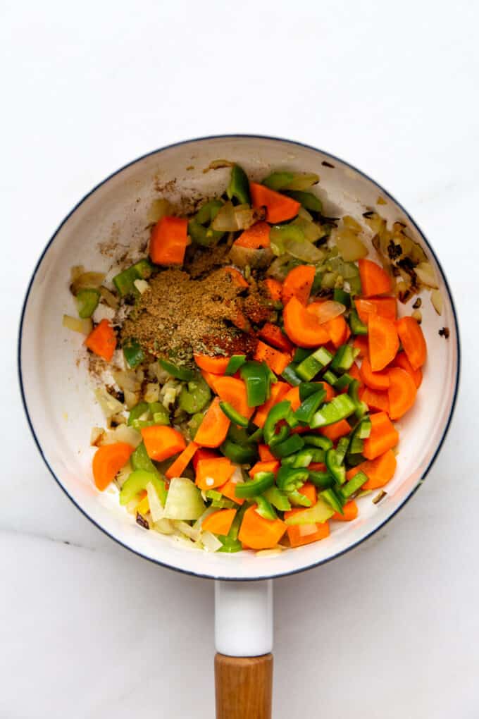 chopped vegetables and spices in a white pot
