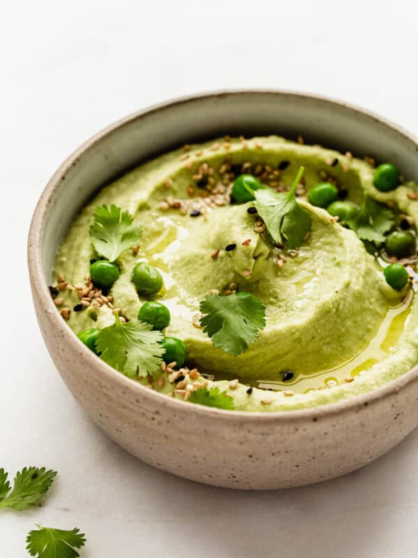 Green pea hummus in a ceramic bowl