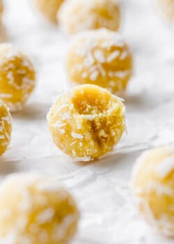 a lemon bliss ball with a bite taken out of it