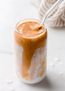 a papaya smoothie in a glass with coconut milk
