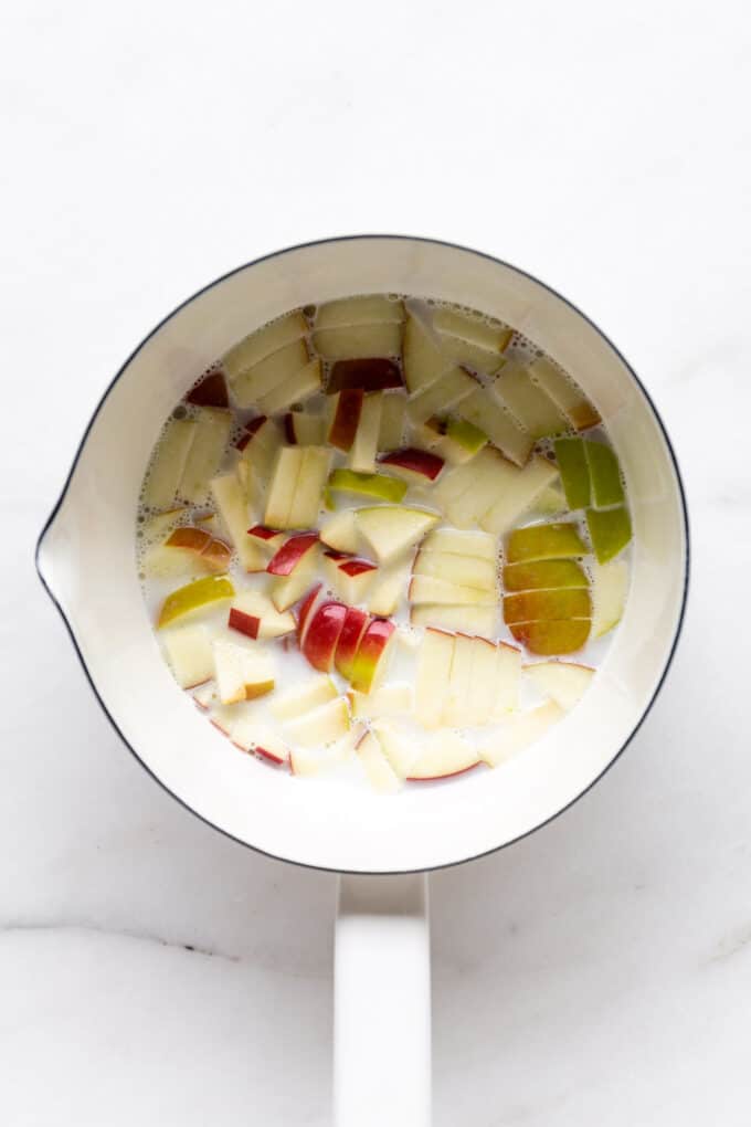 almond milk and apples in a white pot