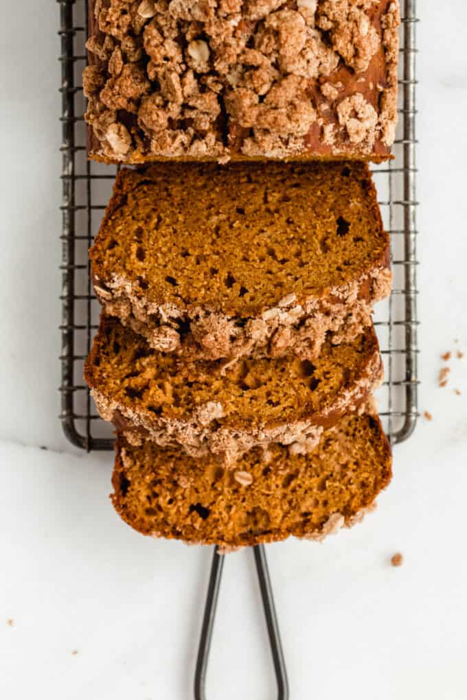 three slices of pumpkin banana bread with streusel topping