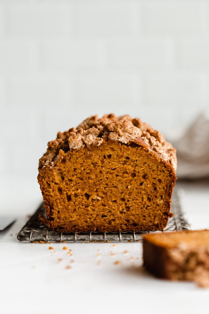 A pumpkin banana bread loaf on a cooling rack