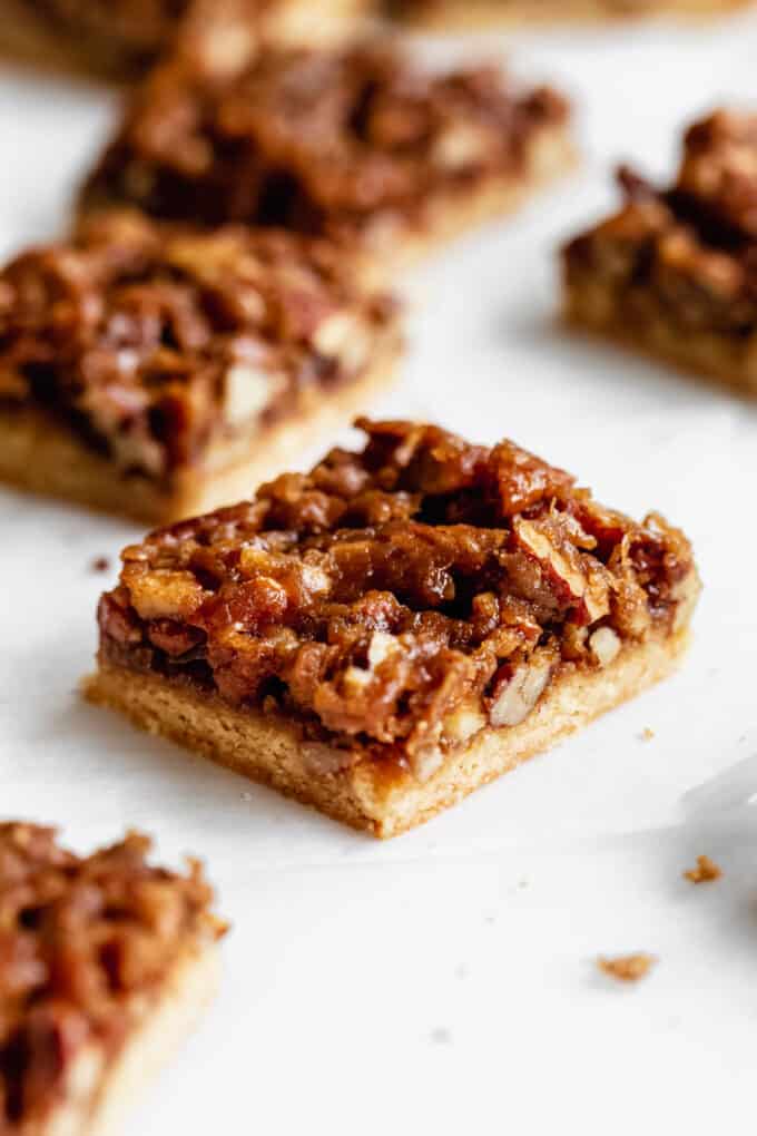 pecan pie bars cut up on a marble board