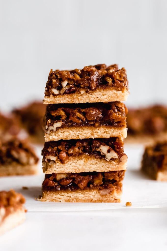a stack of four pecan pie bars on a marble board