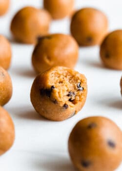 a pumpkin protein ball with a bite taken out of it