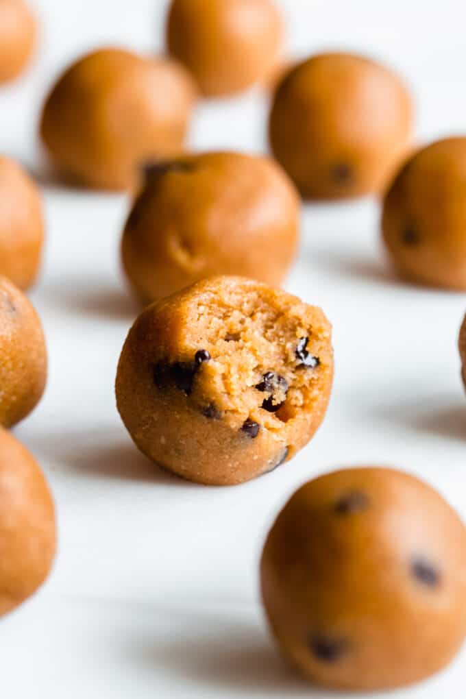 a pumpkin protein ball with a bite taken out of it