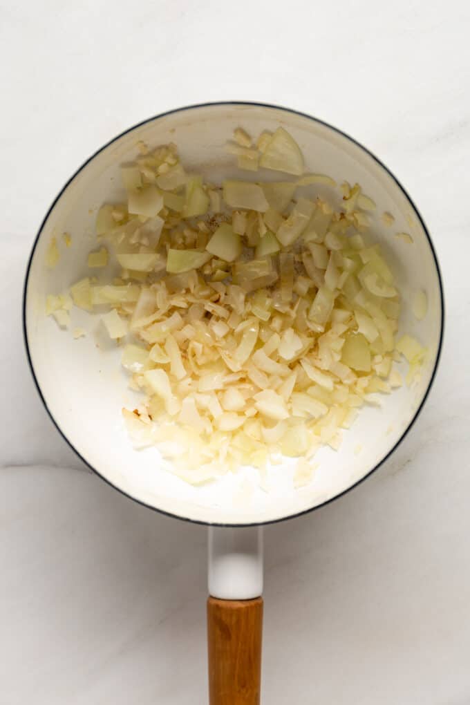 sautéed onions and garlic in a white pot