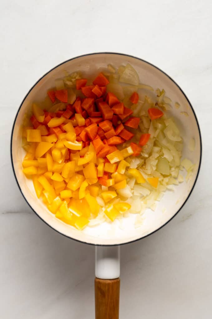 chopped peppers, carrots and onions in a pot