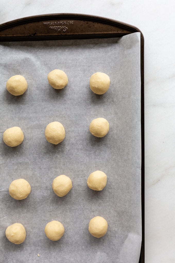 almond snowball cookie dough on a baking sheet