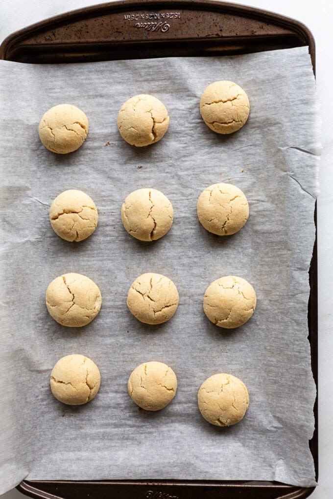 almond snowball cookies baked on a baking sheet