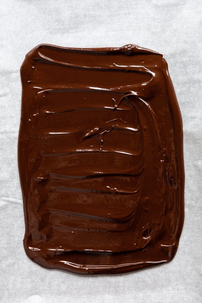 dark chocolate spread onto a piece of parchment paper