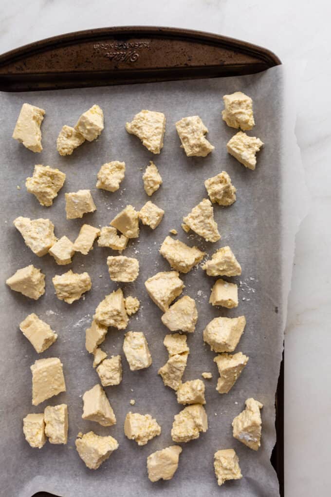 tofu ripped into nuggets on a baking sheet