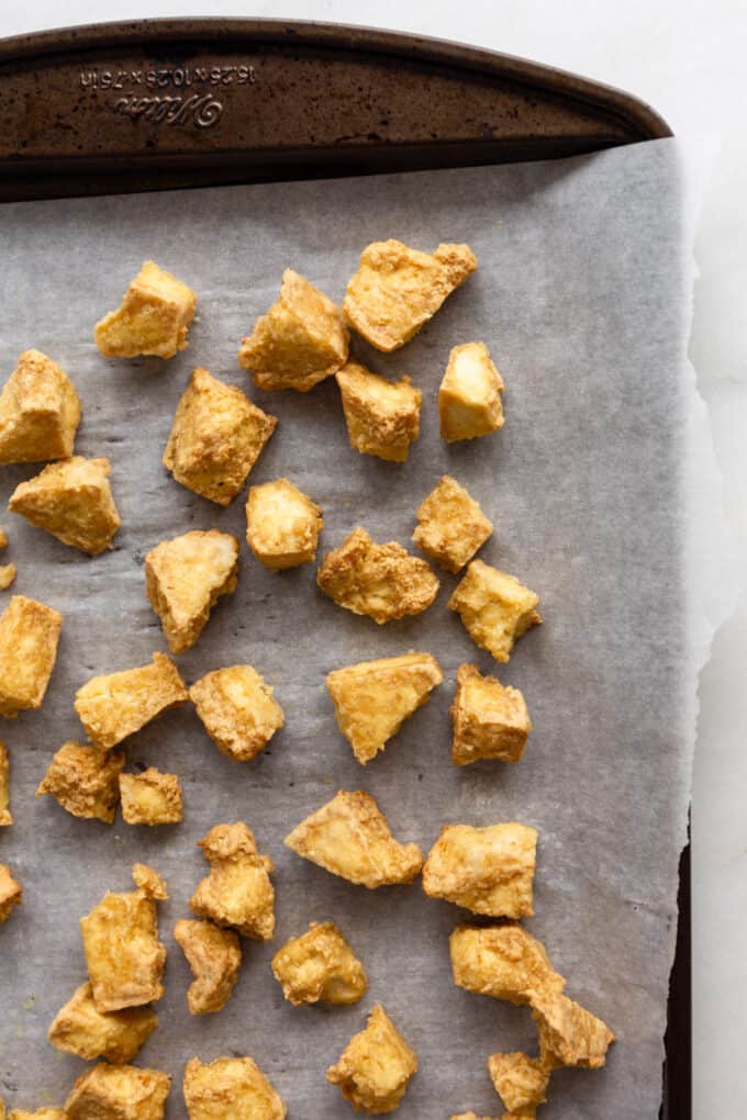 crispy tofu cubes on a baking sheet