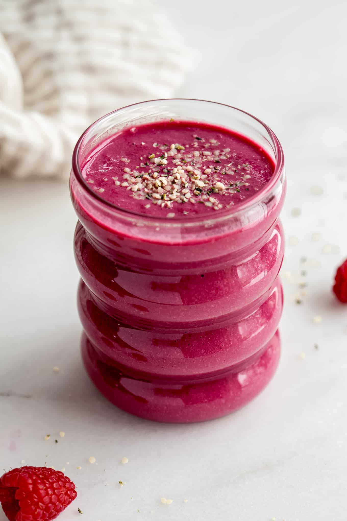a glass of beet smoothie with a napkin in the background