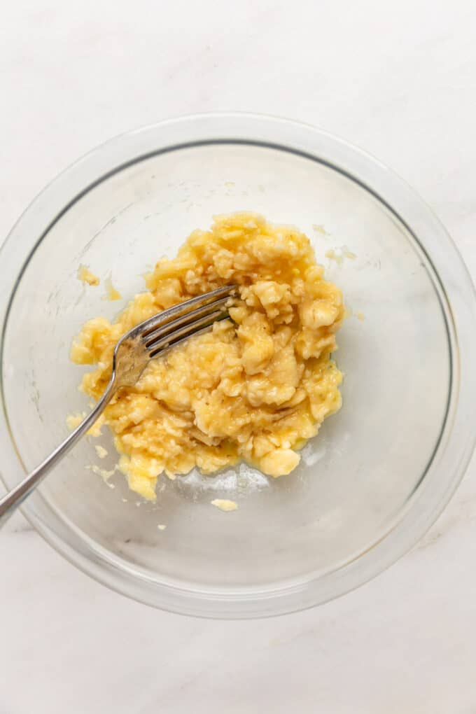 mashed banana in a mixing bowl