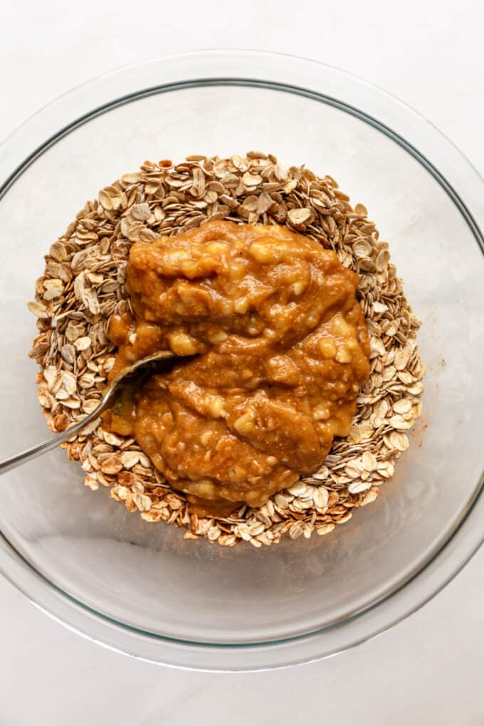 oats and wet ingredients for banana oatmeal bars in a mixing bowl