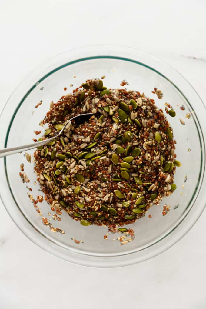 chia, flax, sunflower, sesame and pumpking seeds in a mixing bowl with water