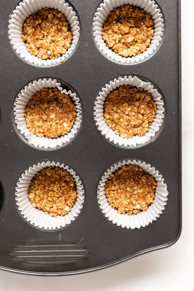 granola crust pressed into the bottom of a mufifn tin