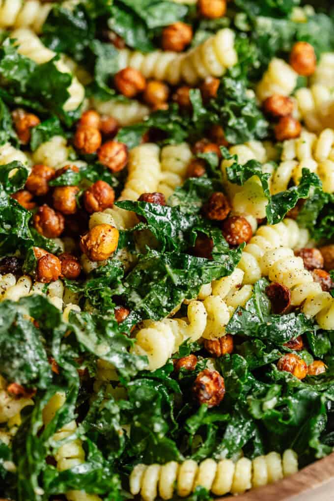 a close up of a kale caesar pasta salad