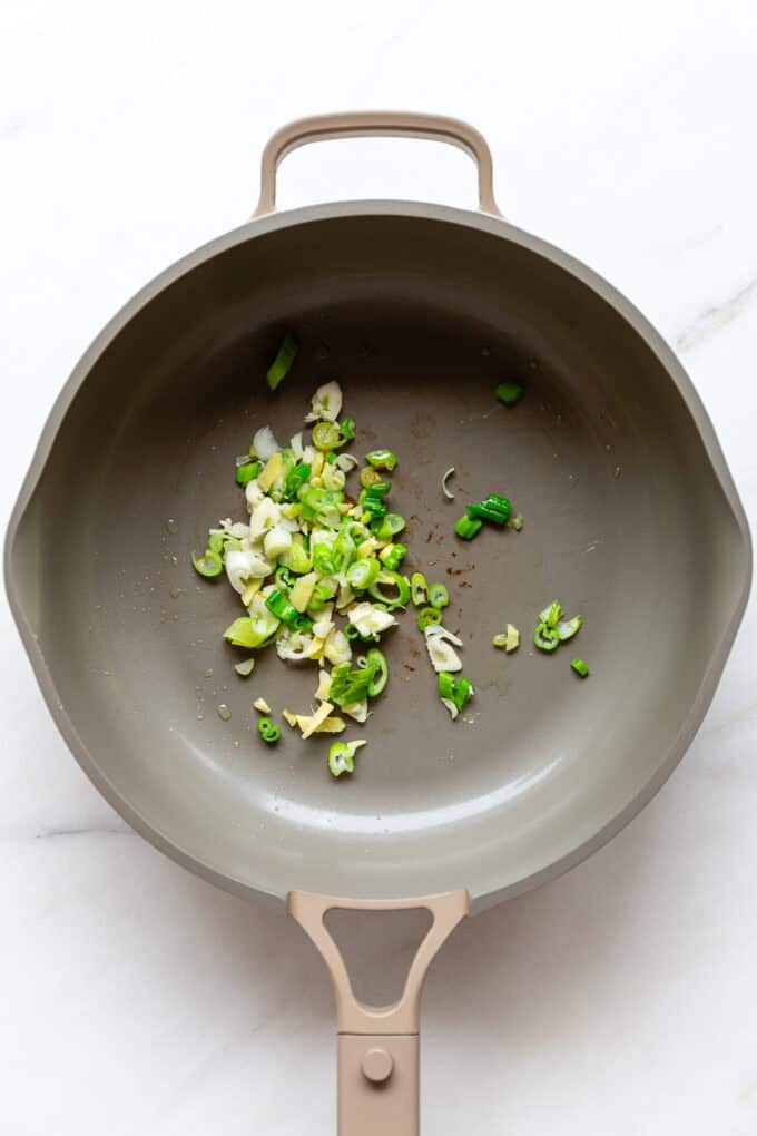green onion, ginger and garlic in a pan