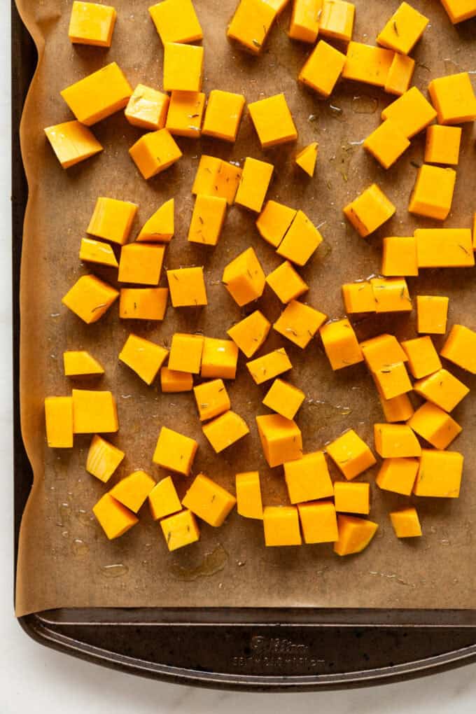 cubed butternut squash on a baking sheet