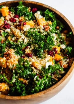 squash, kale and quinoa salad in a wooden bowl