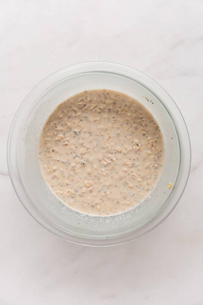 snickers overnight oats in a clear mixing bowl