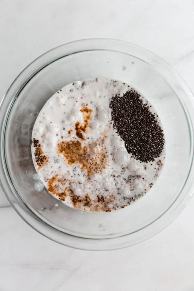 milk, chia seeds and chai spices in a clear mixing bowl