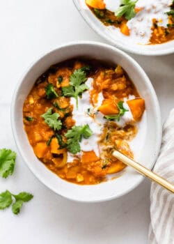 A bowl of sweet potato lentil curry topped with cilantro