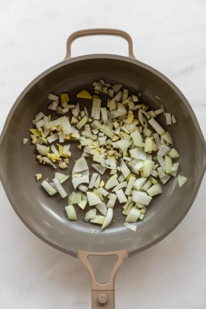sautéd garlic, onion and ginger in a taupe pan