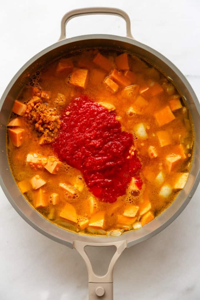 sweet potato, red lentils, broth and crushed tomato in a taupe pan