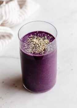 A berry protein smoothie topped with hemp seeds
