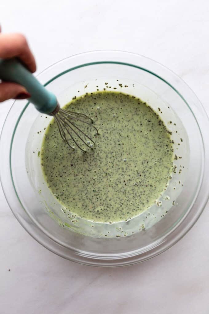 chia pudding being whisked in a mixing bowl
