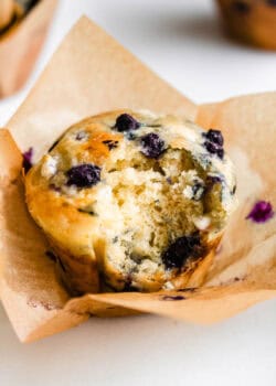 A cottage cheese blueberry muffin with a bite taken out of it