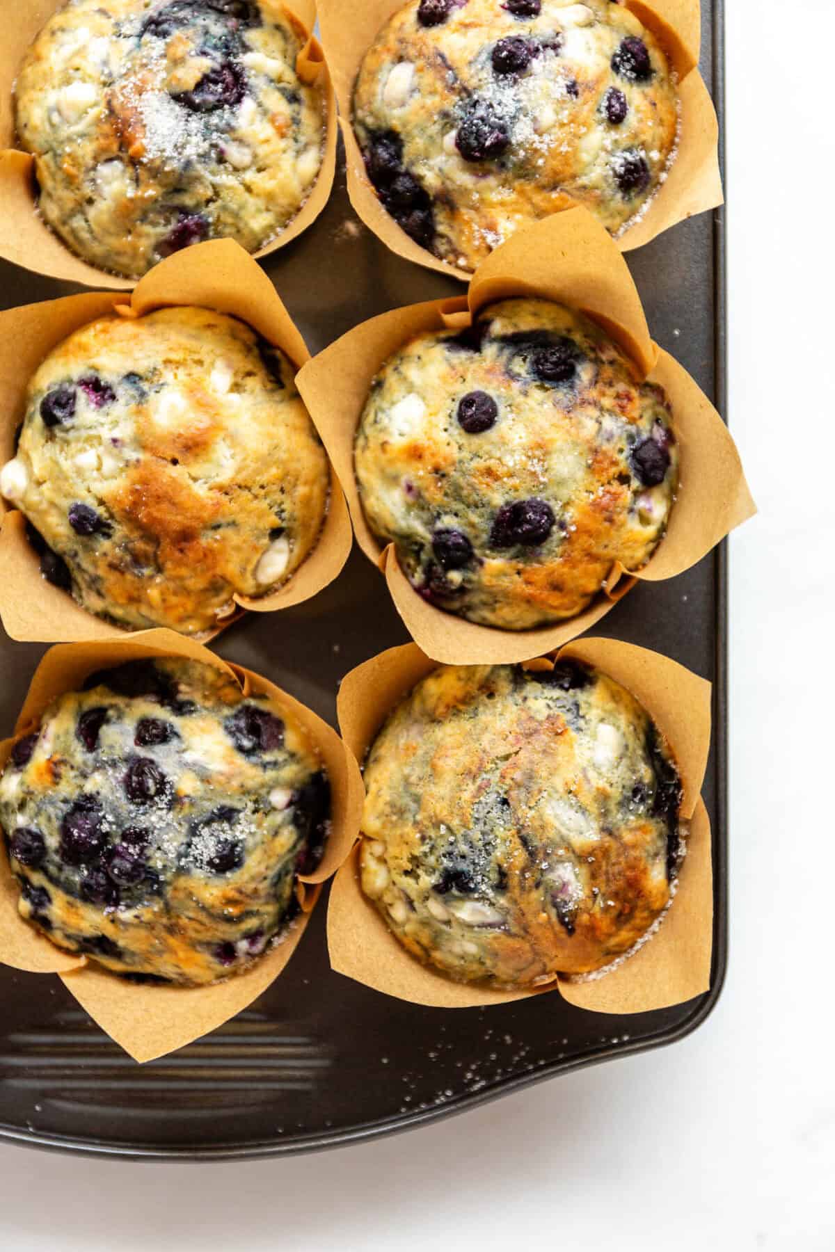 blueberry cottage cheese muffins in a muffin pan