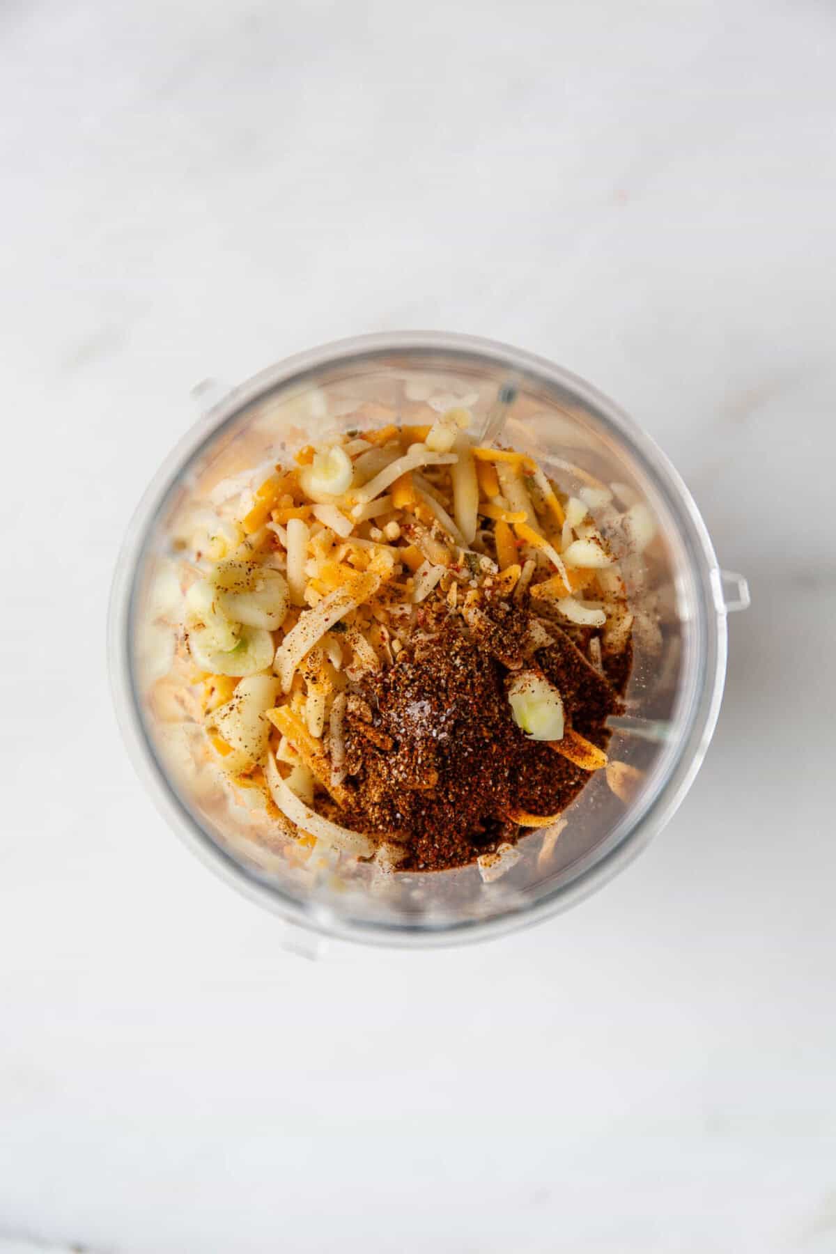 Cottage cheese, shredded cheese, spices and garlic in a small blender container.