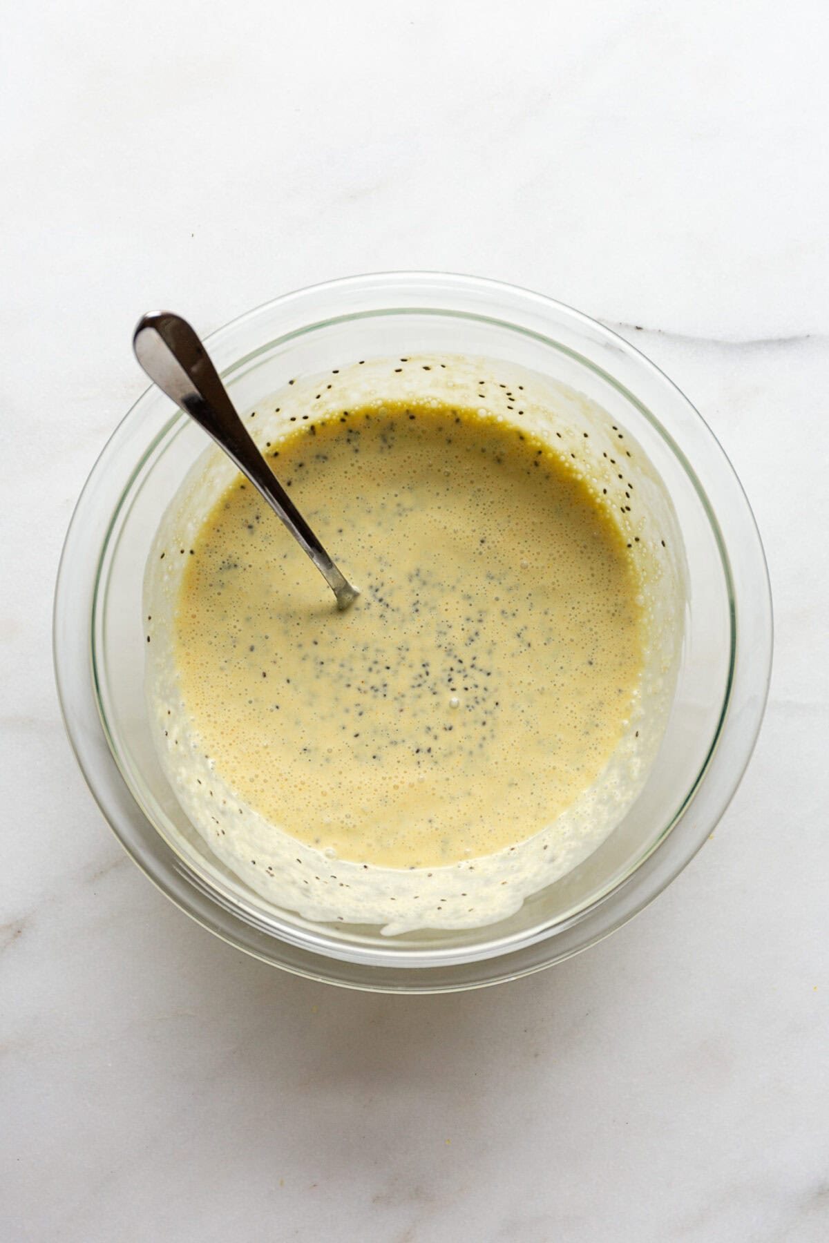 Unchilled lemon chia pudding in a mixing bowl.