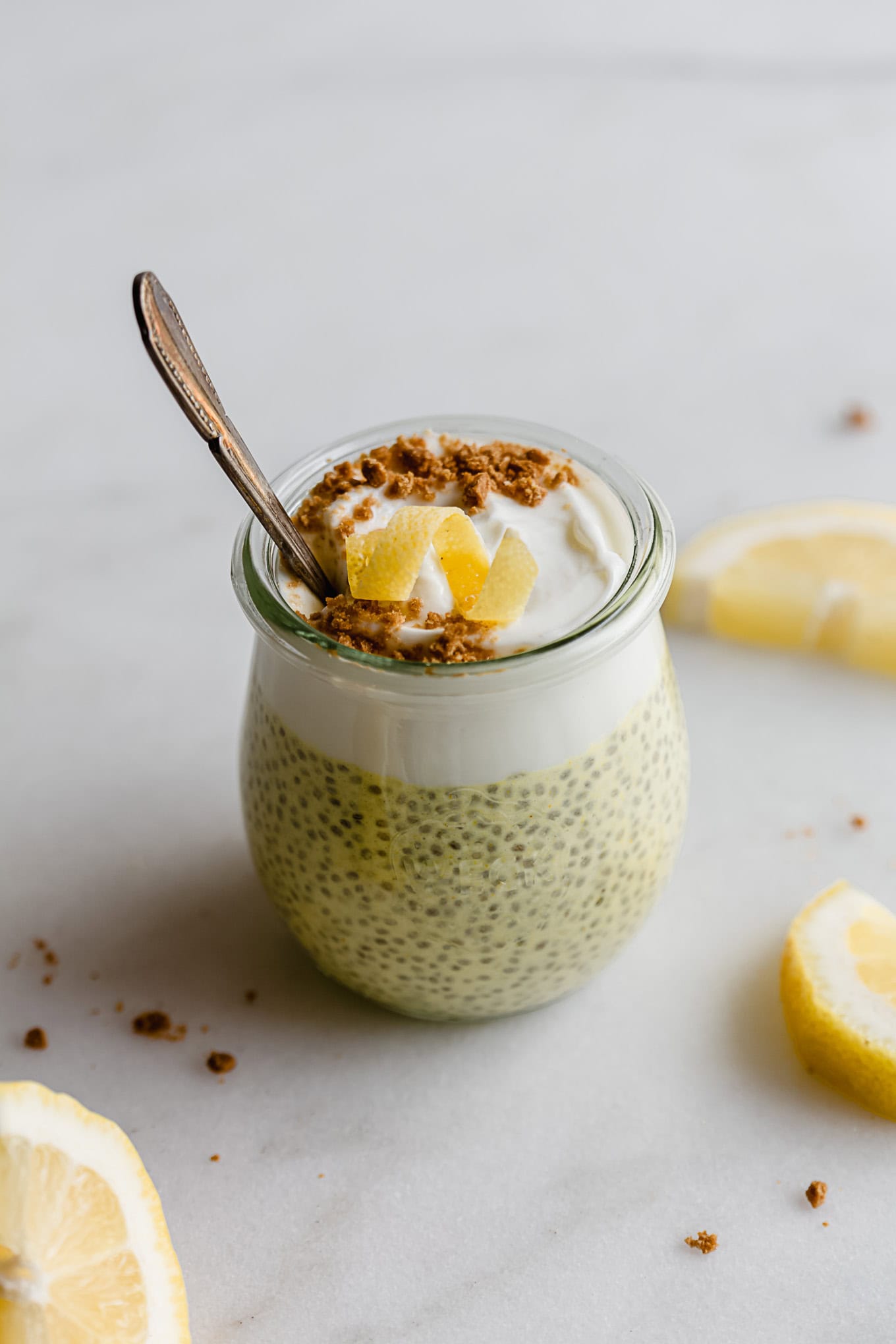 A cup of lemon chia pudding topped with yogurt and lemon zest.