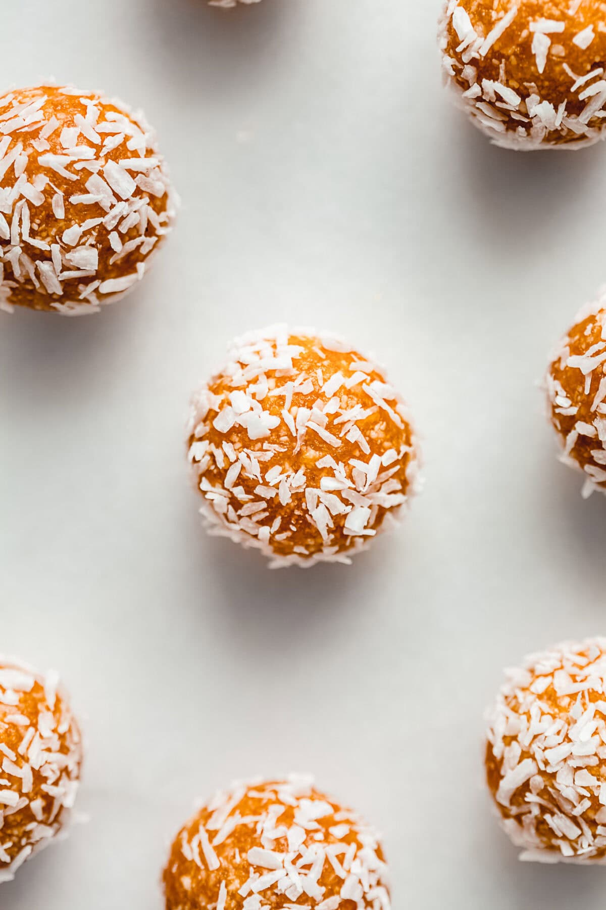 apricot energy balls on a marble board.