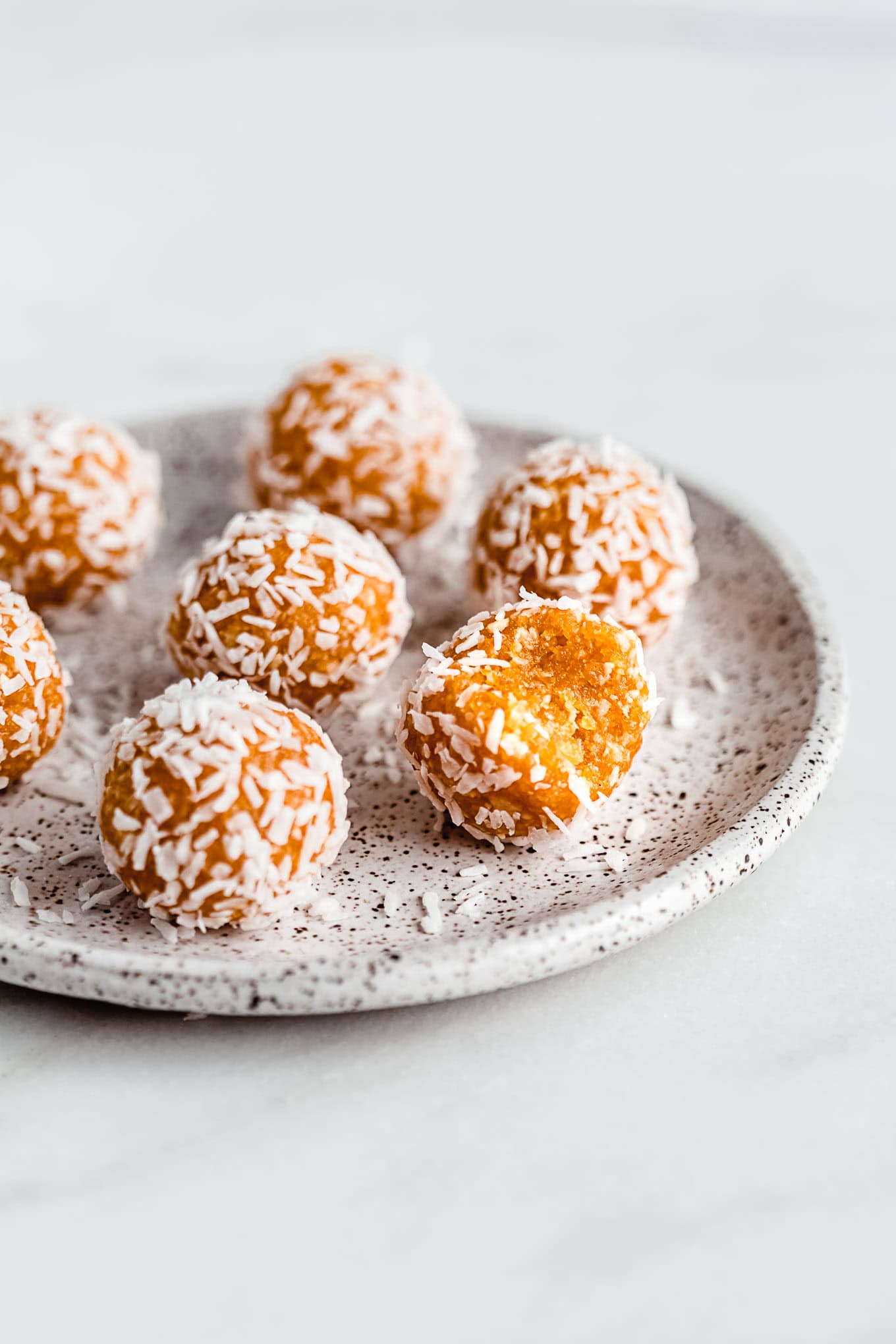Apricot energy balls on a plate.
