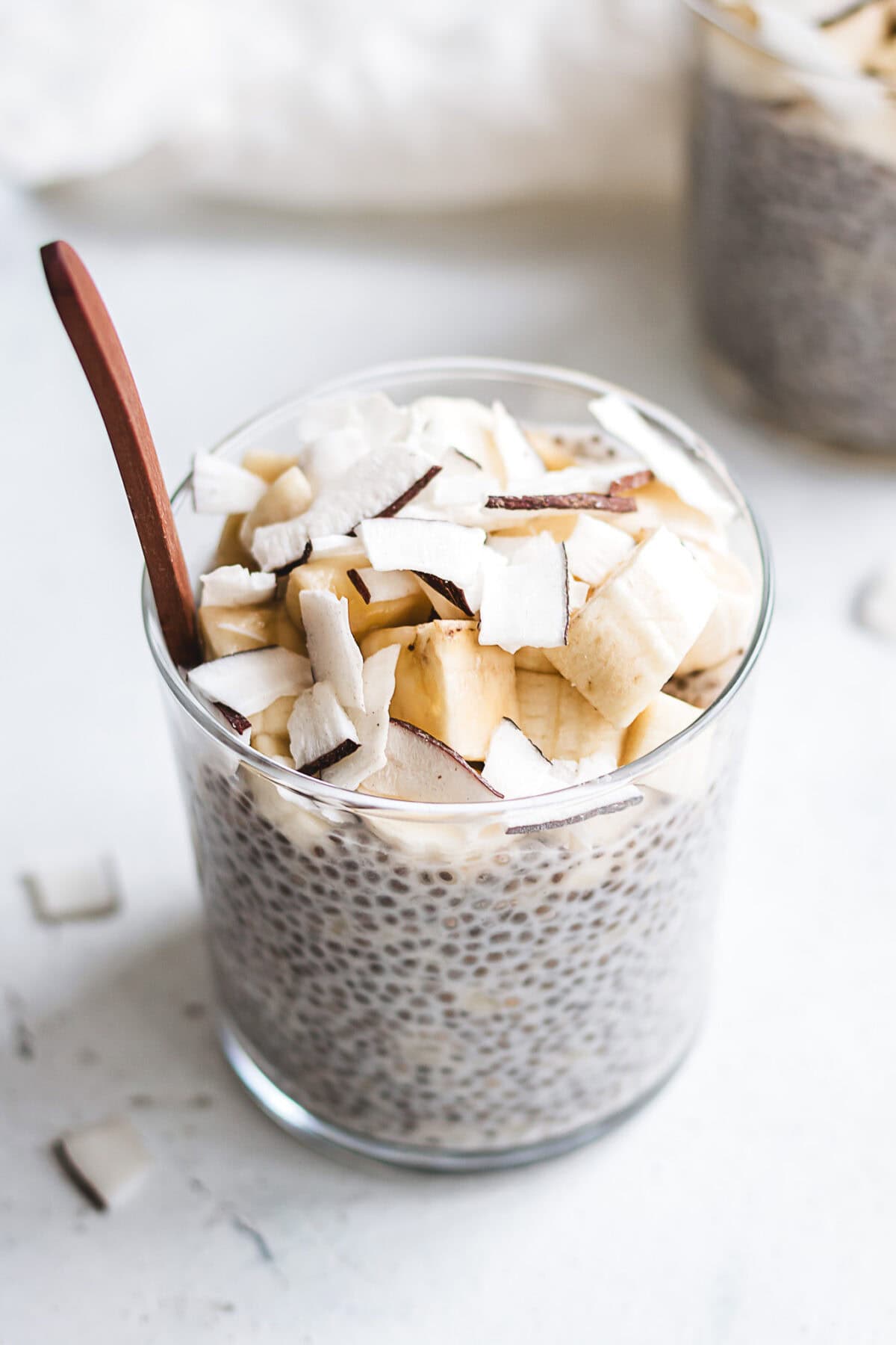 banana chia pudding in a cup topped with banana.