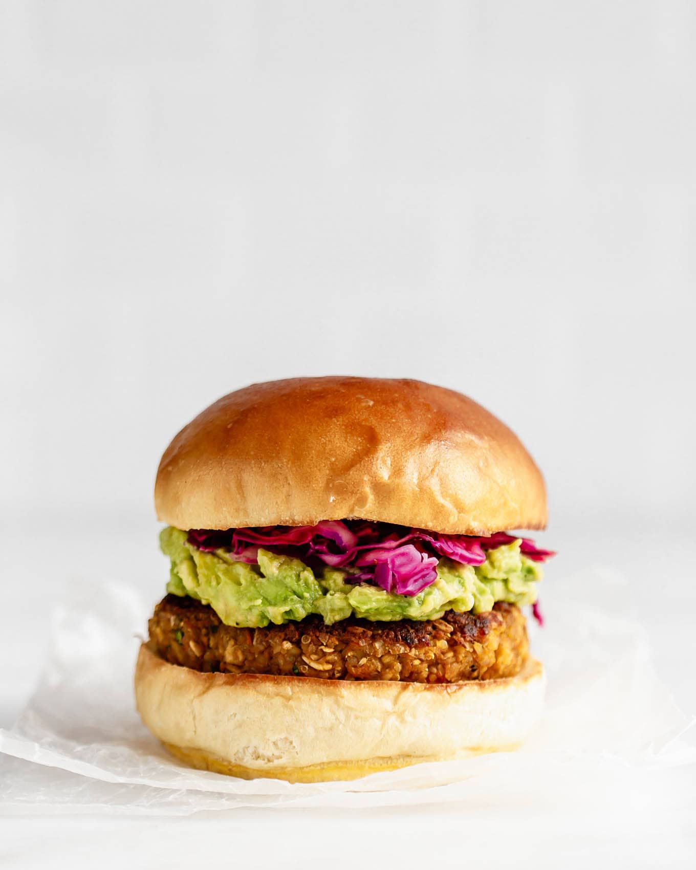 A chickpea burger on parchment paper.