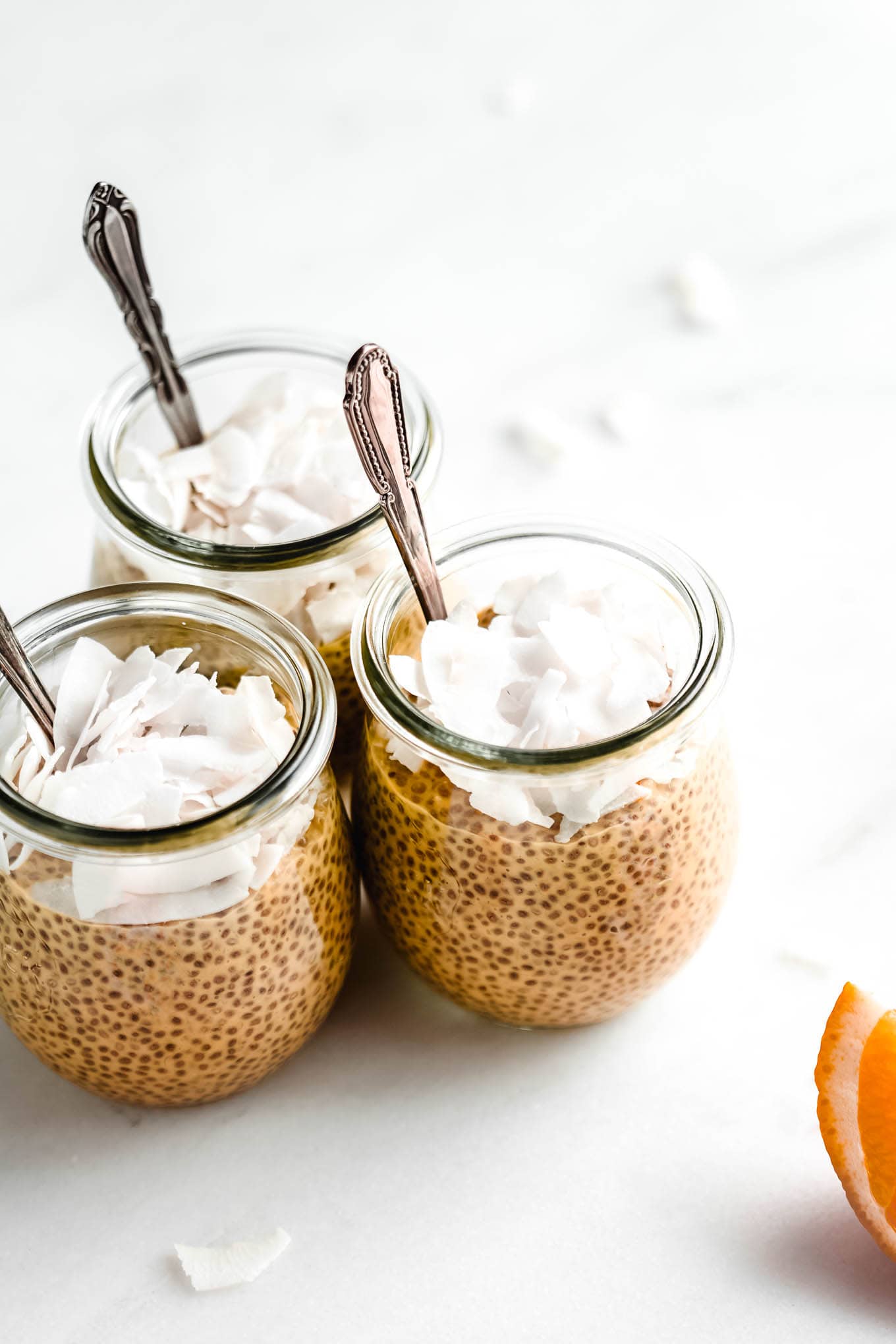 three jars of orange creamsicle chia pudding.