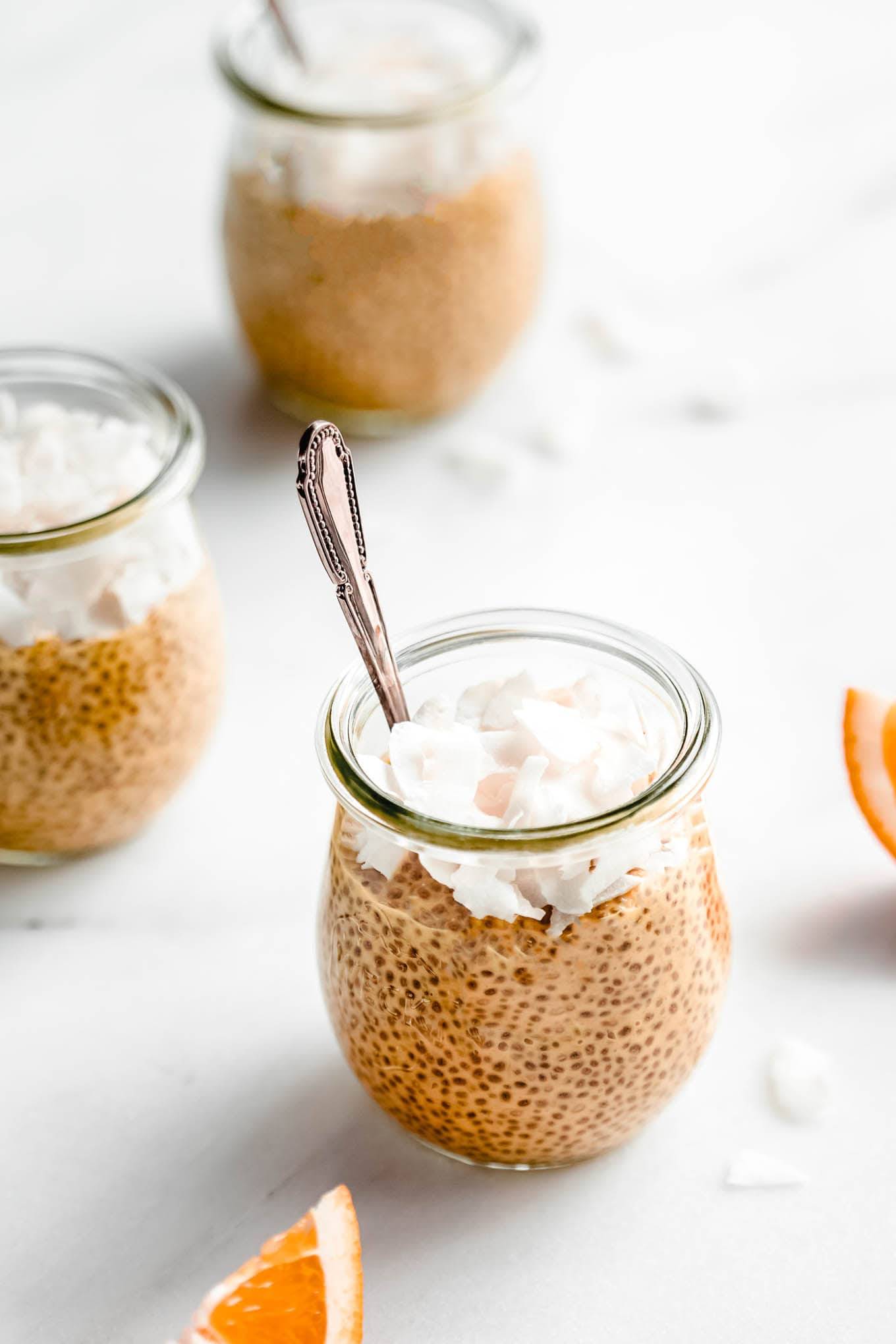 orange creamsicle chia pudding with a spoon.